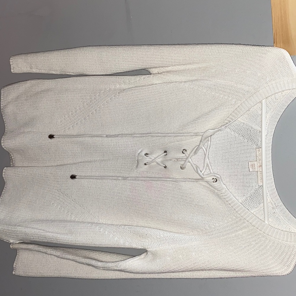 White V-neck sweater with cross lacing on chest